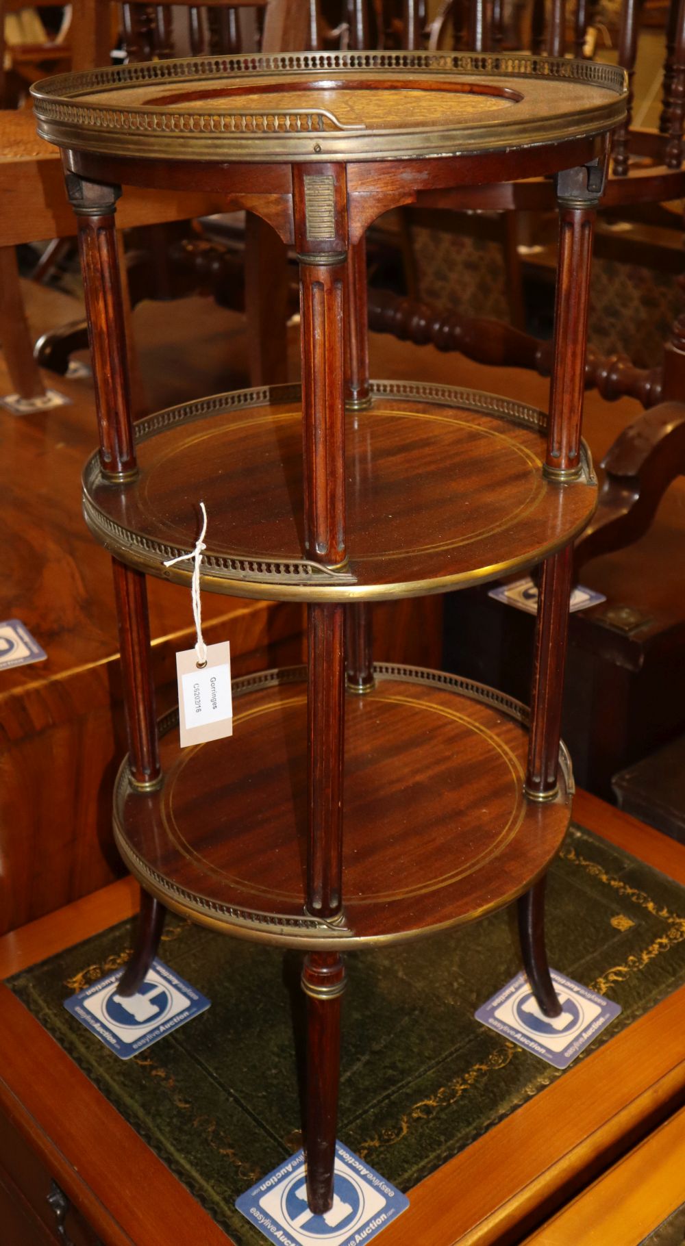 A late 19th century French circular mahogany and brass three tier etagere, 36cm diameter, H.76cm